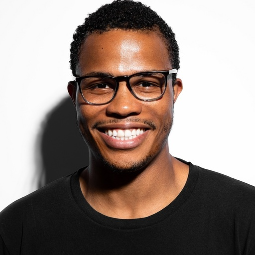 Peter Newton smiling, wearing glasses